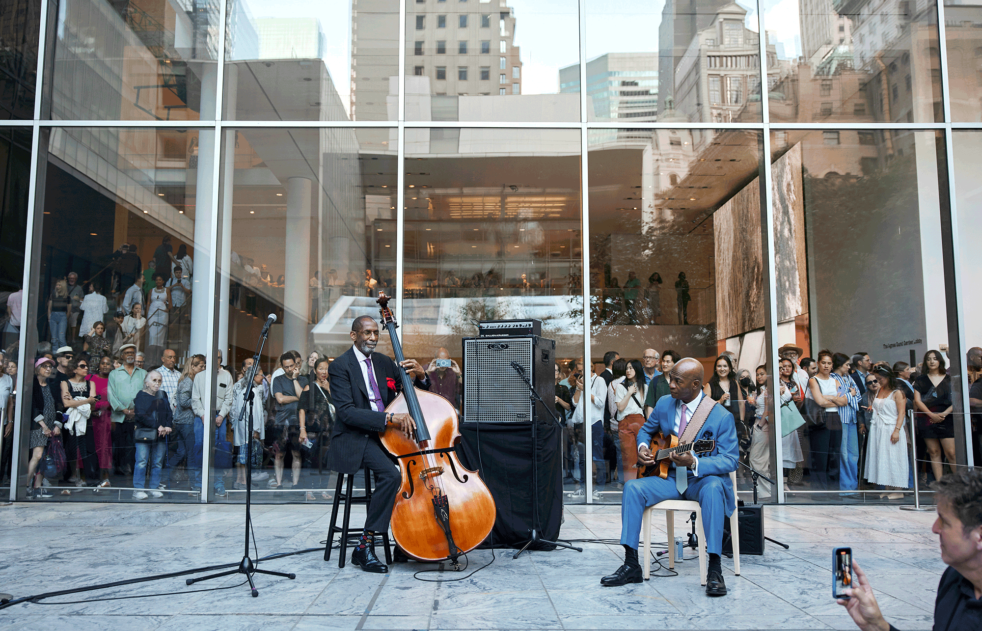 Performers unknown, Jazz in the Garden. c. 1960. Photo: Dan Budnik. Photographic Archive. The Museum of Modern Art Archives, New York; Ron Carter and Russell Malone perform at a MoMA Member Evening to celebrate the launch of the Jazz in the Garden podcast, May 28, 2024. Photo: Alycia Kravitz